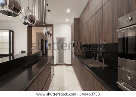 Brown wooden kitchen with iron fixtures and extract