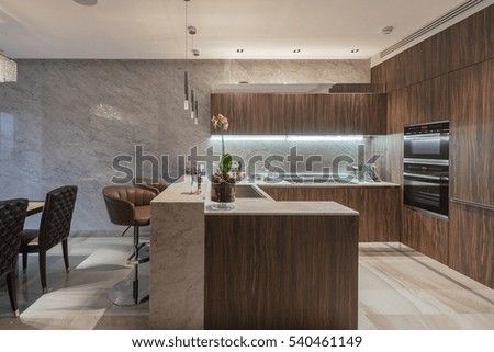 Brown wooden kitchen with iron fixtures and extract