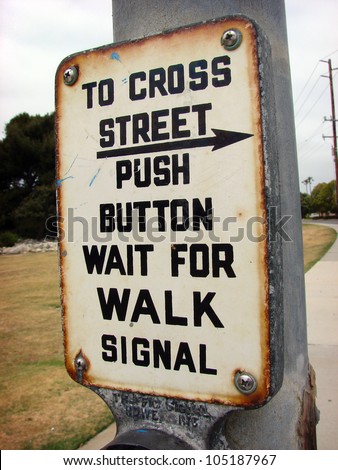 aged and worn vintage photo of  crosswalk button sign