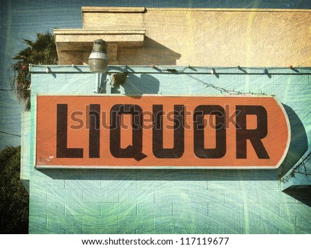aged and worn vintage liquor store sign