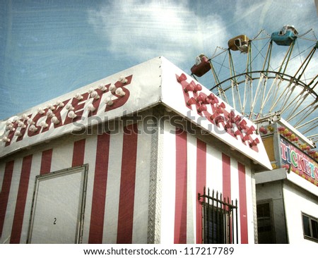 aged and worn vintage photo of ticket booth with ferris wheel