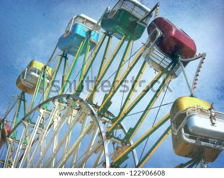 aged and worn vintage photo of carnival ferris wheel ride