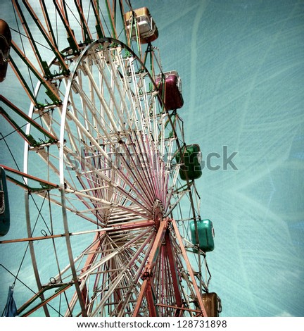 aged and worn vintage photo of carnival ferris wheel