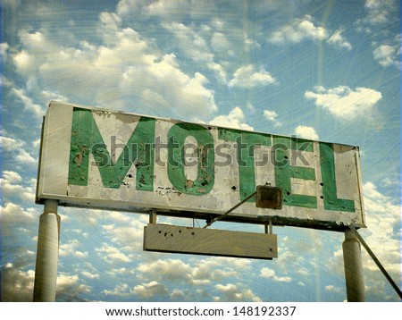 aged and worn vintage photo of old motel sign