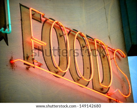aged and worn vintage photo of neon food sign