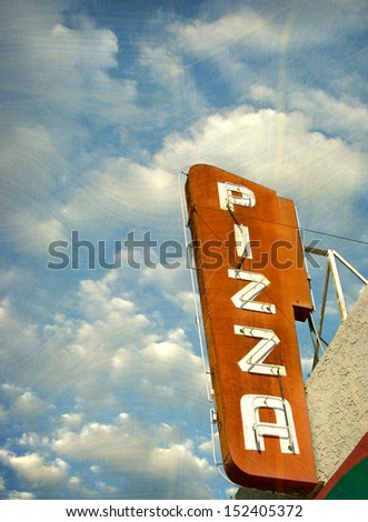 aged and worn vintage photo of neon pizza sign