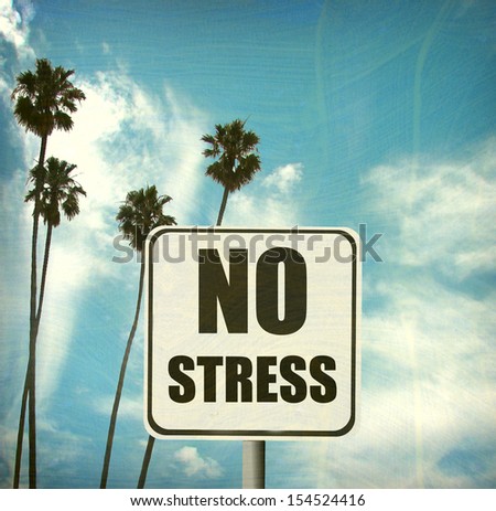 aged and worn vintage no stress sign with palm trees