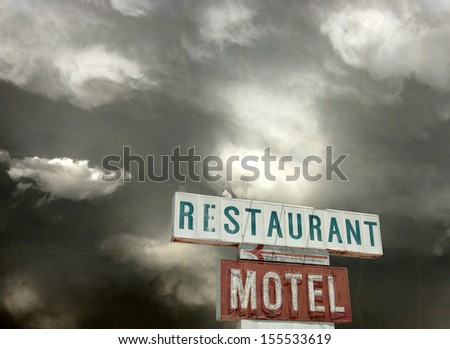 aged and worn vintage photo of restaurant sign and storm clouds