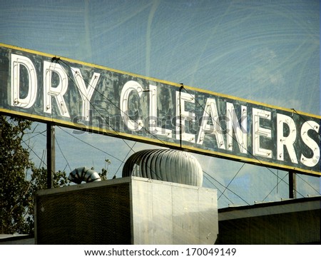 aged and worn vintage photo of neon dry cleaners sign