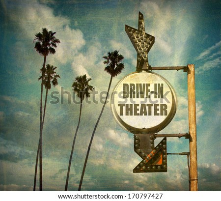 agerd and worn vintage photo of  drive in theater sign with arrow