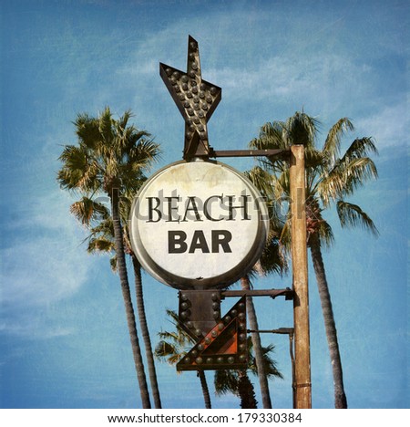 aged and worn vintage photo of beach bar sign with palm trees