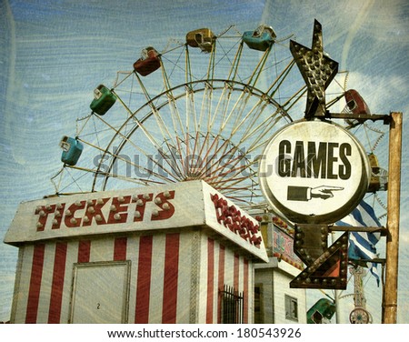 aged and worn vintage photo of retro carnival with games sign