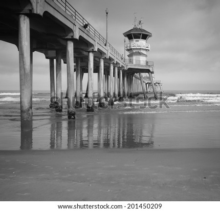black and white ocean pier with waves