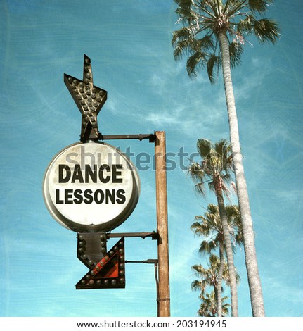 aged and worn vintage photo of dance lesson sign and palm trees