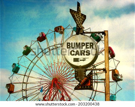 aged and worn vintage photo of bumper cars sign at carnival with ferris wheel