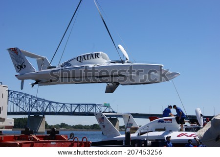 KENNEWICK, WA - JULY 25 : Hydroplane racing boat in sky being lifted by crane during Tri-Cities Water Follies annual event