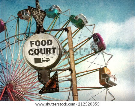 aged and worn vintage photo of food court sign at carnival
