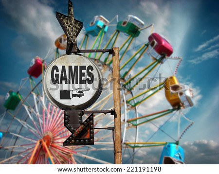 aged and worn vintage photo of games sign at carnival with ferris wheel