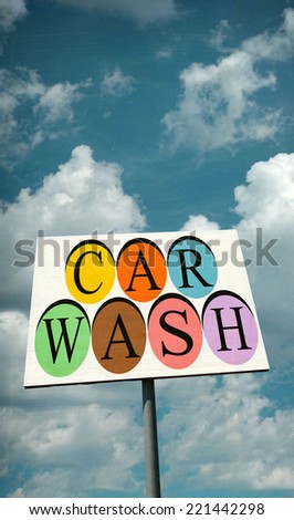 aged and worn vintage photo of car wash sign with clouds and room for text