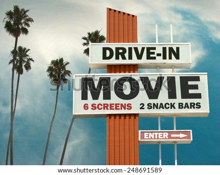 aged and worn vintage photo of  drive in movie sign with palm trees