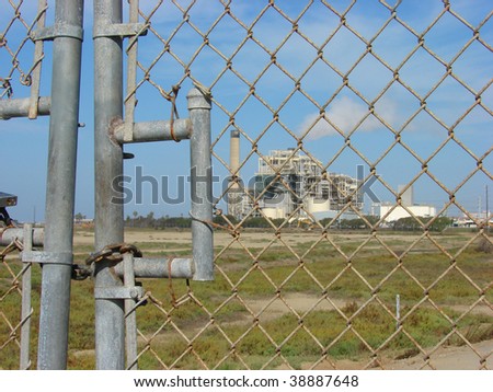 industrial factory behind locked fence