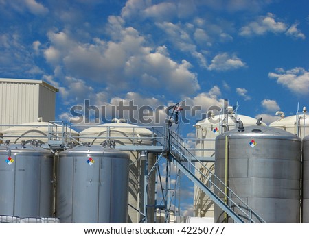 Industrial tanks and silos with cloudy sky