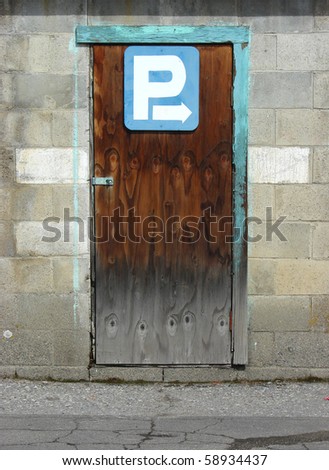 Parking directions sign on old wooden door