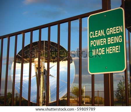 clean green powers sign with parabolic dish solar energy collector in background