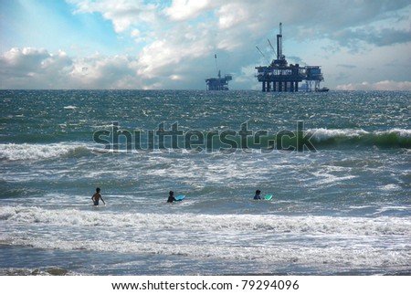 oil platform with surfers and big waves