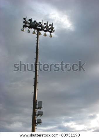 football stadium light tower with stormy sky and room for text