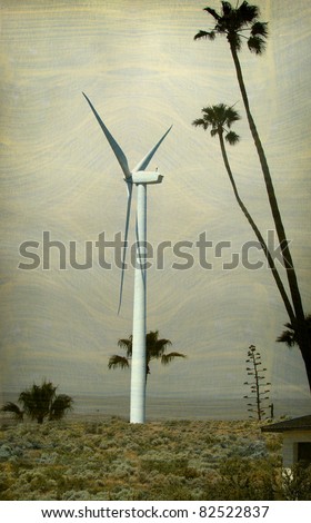 aged and worn vintage photo of wind turbine and palm trees with ocean in background