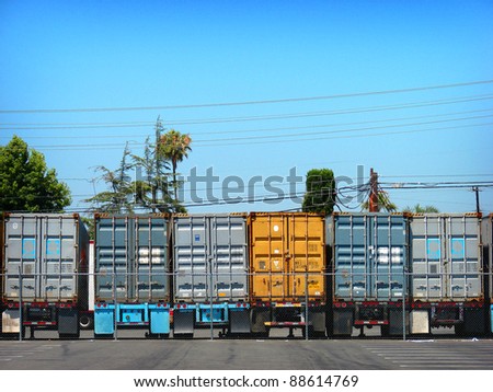 row of 18 wheel semi truck trailers