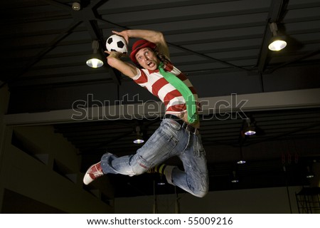 a crazy soccer or football fan leaping to do a throw in with the soccer ball