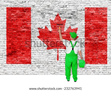 Professional house painter covers brick wall with flag of Canada