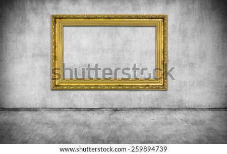 old golden empty frame on gray wall