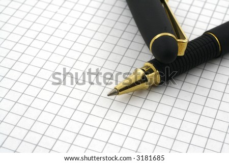 close-up of pen tip and blank squared paper