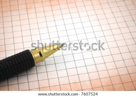 close-up of pen tip and blank stained paper