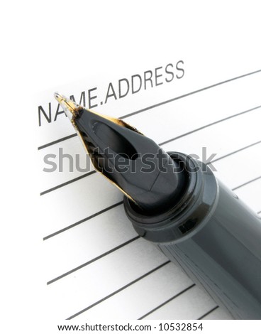 close-up of pen tip and address book
