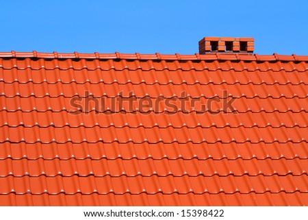 red roofing-tiles with blue sky above