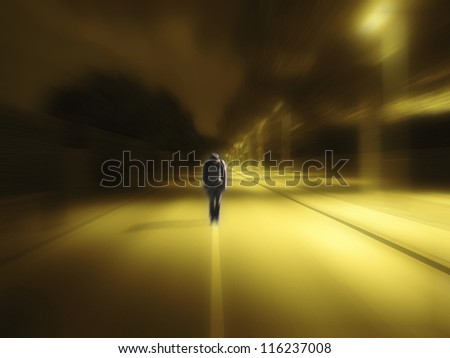 Lonely guy in darkness on the middle of road