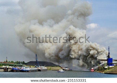 DUISBURG, GERMANY - 11 September 2010 Fire with smoke on a scrap island in the  Logport inland port of Duisport.