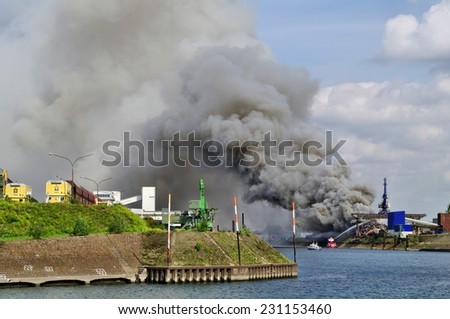 DUISBURG, GERMANY - 11 Septembert 2010 Fire with smoke on a scrap island in the  Logport inland port of Duisport.