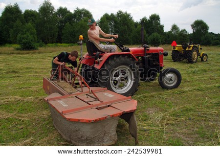 KOSMIDRY, POLAND - July 01, 2014 Old tractor repair in the field and and friendly help neighbors