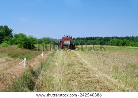 KOSMIDRY, POLAND - July 29, 2013 The combine moves to a field and collects wheat closeup