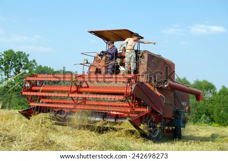 KOSMIDRY, POLAND - July 29, 2013 The combine moves to a field and collects wheat closeup