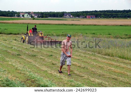 KOSMIDRY, POLAND - July 01, 2014 Old tractor repair in the field and and friendly help neighbors
