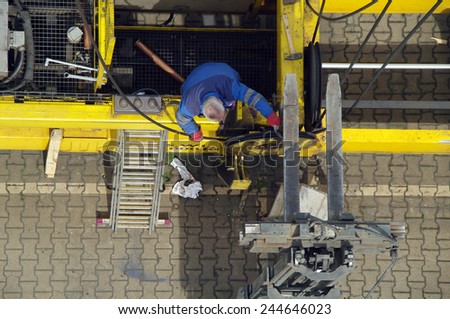 DUISBURG, GERMANY - 17 April 2014 Portal-crane servicing on automatic spreader in Logistics Center - Logport Duisburg