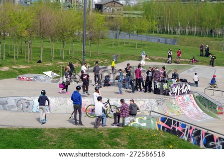 DUISBURG, GERMANY - 19 April 2015 The river bank Rhine. Skateboarders with friends in skate-park jumping in the halfpipe and on the other ramp