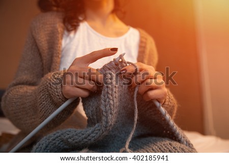 Close-up of woman hands knitting colorful wool yarn. Close-up horizontal photo. Freelance creative working and living concept