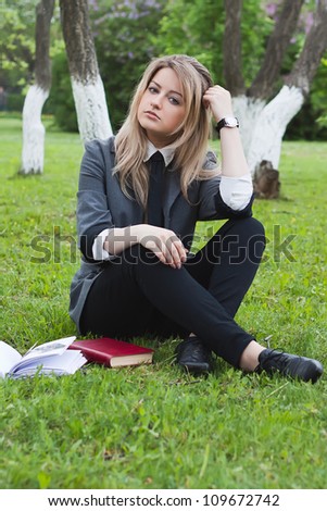 Girl reads a book in a spring garden